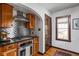 Chef's kitchen with a stainless steel range hood and dark countertops at 6280 Washington Blvd, Indianapolis, IN 46220