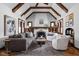 Bright living room with vaulted ceilings, exposed beams, fireplace, and cozy seating arrangement at 6280 Washington Blvd, Indianapolis, IN 46220