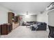 Spacious living room featuring a large sofa, entertainment center, and a bright window at 6280 Washington Blvd, Indianapolis, IN 46220