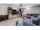 A finished living room featuring a plush gray sofa, wood entertainment center, and cozy decor at 6280 Washington Blvd, Indianapolis, IN 46220
