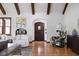 Open-concept living room featuring hardwood floors, wooden beams and stylish decor at 6280 Washington Blvd, Indianapolis, IN 46220