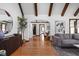 Inviting living room showcasing hardwood floors and an open floor plan with exposed beams at 6280 Washington Blvd, Indianapolis, IN 46220