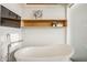 Elegant bathroom boasts a freestanding tub with a wall-mounted television and stylish decor at 630 N College Ave # 409, Indianapolis, IN 46204
