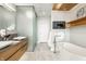 Stunning bathroom with dual sinks, soaking tub, and glass-enclosed shower offers a spa-like experience at 630 N College Ave # 409, Indianapolis, IN 46204