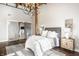Bright bedroom featuring a chandelier, frosted sliding glass doors and a comfortable bed with soft textures at 630 N College Ave # 409, Indianapolis, IN 46204