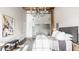 Bright bedroom featuring a high ceiling, chandelier, and a comfortable bed with soft textures, creating a relaxing retreat at 630 N College Ave # 409, Indianapolis, IN 46204