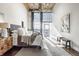 Serene bedroom featuring a large window, modern lighting, and a comfortable bed with soft textures, offering a relaxing retreat at 630 N College Ave # 409, Indianapolis, IN 46204