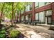 A lovely brick building and tree lined courtyard with patio seating at 630 N College Ave # 409, Indianapolis, IN 46204