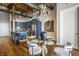 Open dining area with view of kitchen with a glass table, unique lighting and comfortable seating at 630 N College Ave # 409, Indianapolis, IN 46204