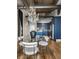 Stylish dining area featuring a modern glass table, chandelier, and an open-concept kitchen with sleek, blue cabinetry at 630 N College Ave # 409, Indianapolis, IN 46204