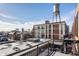 Exterior view featuring an industrial building with a water tower and cityscape views from a balcony, capturing urban living at 630 N College Ave # 409, Indianapolis, IN 46204