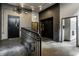 Hallway with elevator, black doors, tile floor and brick walls at 630 N College Ave # 409, Indianapolis, IN 46204