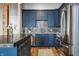 Close-up view of a modern kitchen featuring dark blue cabinets and stainless-steel appliances at 630 N College Ave # 409, Indianapolis, IN 46204