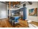 Open-concept kitchen with dark blue cabinetry, stainless steel appliances, and a large island with barstool seating at 630 N College Ave # 409, Indianapolis, IN 46204