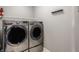 Modern laundry area featuring side-by-side washer and dryer units with clean, neutral decor at 630 N College Ave # 409, Indianapolis, IN 46204