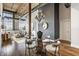 Bright and airy living room with large windows, exposed brick, hardwood floors, and a unique glass-topped table on a wood base at 630 N College Ave # 409, Indianapolis, IN 46204