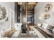 Open-concept living space showcasing a leather sofa, an armchair, a dining area, and modern decor with exposed ductwork at 630 N College Ave # 409, Indianapolis, IN 46204