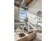 Cozy living room with exposed brick wall, large window, modern furnishings, and a decorative art piece adding character at 630 N College Ave # 409, Indianapolis, IN 46204
