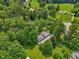 Wide aerial view of property nestled among dense trees at 6691 N Baltimore Rd, Monrovia, IN 46157