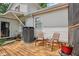Wooden back deck featuring patio furniture, an air conditioner, and a view of the home's exterior at 6691 N Baltimore Rd, Monrovia, IN 46157
