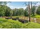 Beautiful backyard area featuring a large pond and garden beds surrounded by trees in the neighborhood at 6691 N Baltimore Rd, Monrovia, IN 46157