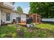 Cozy backyard with a screened in structure and a wood deck surrounded by green grass and lovely plants at 6691 N Baltimore Rd, Monrovia, IN 46157