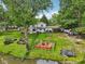 Expansive backyard featuring a deck, mature trees, and lush greenery, perfect for outdoor living at 6691 N Baltimore Rd, Monrovia, IN 46157