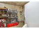 Unfinished basement with storage shelves, pet cages, and a white refrigerator at 6691 N Baltimore Rd, Monrovia, IN 46157