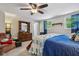 Carpeted bedroom with a blue comforter set, wood furniture, closet, and ceiling fan at 6691 N Baltimore Rd, Monrovia, IN 46157