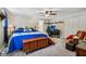 Bedroom with a blue quilted bedspread, ceiling fan, adjacent computer desk, and closet at 6691 N Baltimore Rd, Monrovia, IN 46157