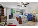 This bedroom has a blue comforter set and ceiling fan and features a wooden trunk with steps to get into bed at 6691 N Baltimore Rd, Monrovia, IN 46157