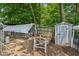 Chicken coop and backyard storage shed surrounded by tall trees, with plenty of greenery at 6691 N Baltimore Rd, Monrovia, IN 46157