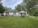 Charming single-story home featuring a cozy front porch, well-maintained lawn, and mature trees at 6691 N Baltimore Rd, Monrovia, IN 46157