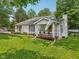 Charming home with a well-manicured lawn and a welcoming front porch, surrounded by mature trees at 6691 N Baltimore Rd, Monrovia, IN 46157