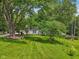 Charming home with a well-manicured lawn and a welcoming front porch, surrounded by mature trees at 6691 N Baltimore Rd, Monrovia, IN 46157