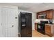 This kitchen features a black refrigerator and black oven with stainless steel microwave at 6691 N Baltimore Rd, Monrovia, IN 46157