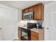 This kitchen features wood cabinets, black oven and countertops with stainless steel microwave at 6691 N Baltimore Rd, Monrovia, IN 46157