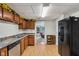 Efficient kitchen layout with black refrigerator and bright lighting at 6691 N Baltimore Rd, Monrovia, IN 46157