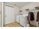 Functional laundry area with washer, dryer, wire shelving, and white door at 6691 N Baltimore Rd, Monrovia, IN 46157