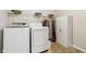 Spacious laundry room featuring a white washer, dryer, shelving and plenty of storage space at 6691 N Baltimore Rd, Monrovia, IN 46157