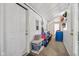 Well-lit mudroom with white walls, storage shelves, and access to the garage, plus gear hanging on wall at 6691 N Baltimore Rd, Monrovia, IN 46157