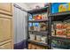 Organized pantry with multiple shelves stocked with food items and household supplies at 6691 N Baltimore Rd, Monrovia, IN 46157