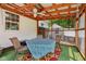 Covered patio with outdoor seating, ceiling fan, artificial turf and view of backyard and shed at 6691 N Baltimore Rd, Monrovia, IN 46157