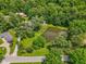 Aerial view of a pond surrounded by lush trees, green grass, and seating area at 6691 N Baltimore Rd, Monrovia, IN 46157
