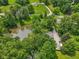 Aerial view of a pond surrounded by lush trees, green grass, and seating area at 6691 N Baltimore Rd, Monrovia, IN 46157