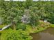 Scenic aerial view of a pond near a cozy home with a large, green, treed yard at 6691 N Baltimore Rd, Monrovia, IN 46157
