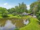 Scenic view of a tranquil pond reflecting trees and blue skies, adding natural beauty to the property at 6691 N Baltimore Rd, Monrovia, IN 46157