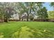 Large, grassy backyard with mature trees, a fenced perimeter, and plenty of space for outdoor activities at 6760 Navigate Way, Indianapolis, IN 46250