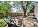 Cozy backyard oasis featuring a modern fire pit surrounded by chairs and mature trees at 6760 Navigate Way, Indianapolis, IN 46250