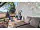 Comfortable backyard with patio featuring outdoor dining, lounge chairs, and an umbrella for shade at 6760 Navigate Way, Indianapolis, IN 46250